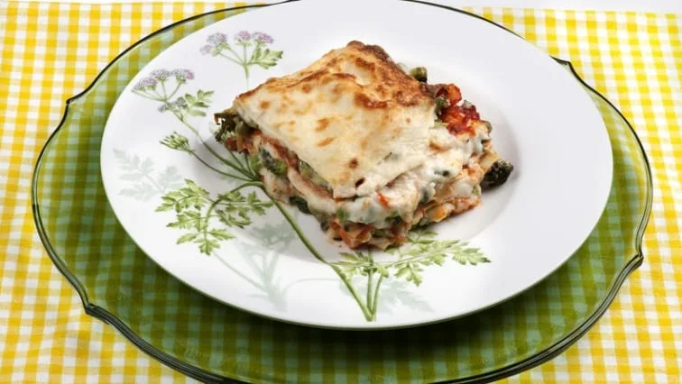 Kousek zeleninového lasagne bez masa na talíři.