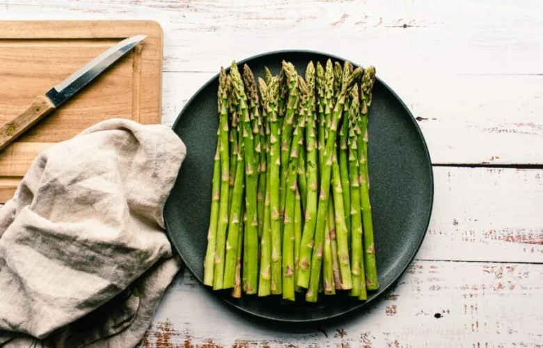 Fresh asparagus spears on plate