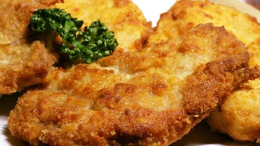 Breaded fried cutlets with parsley garnish