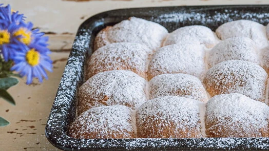 Powdered sugar buns in tray